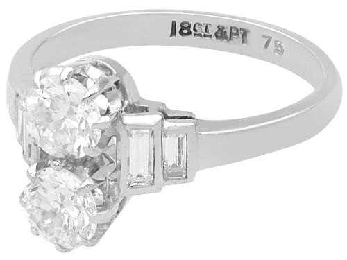 fig 4. An Art Deco 18ct white gold two-stone diamond ring with stepped baguette cut diamond shoulders.