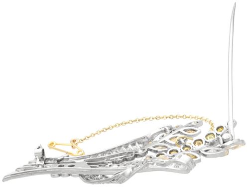 fig 8. An Art Deco diamond brooch designed as a stylized flower spray with yellow and white diamonds mounted in palladium with a safety chain.