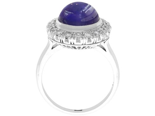 fig 7. An Art Deco platinum cluster ring featuring a central cabochon star sapphire encircled by a halo of round diamonds with millegrain edging.