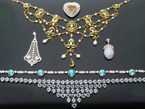 fig 5. An 18ct yellow gold Belle Epoque festoon necklace featuring faceted green peridots, intricate scrollwork, and suspended natural pearl drops.