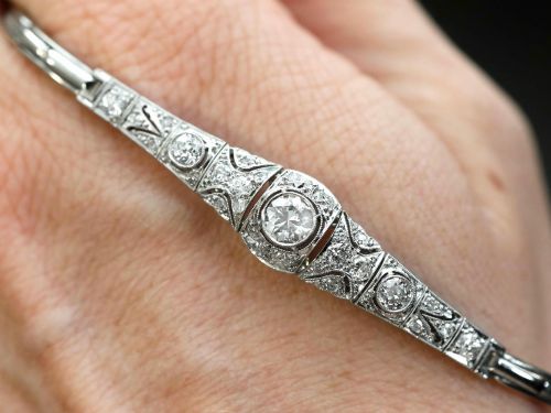 fig 3. An Art Deco 18ct white gold bracelet featuring articulated geometric panels set with diamonds and finished with millegrain edging.