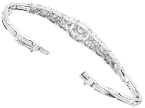 fig 8. An Art Deco 18ct white gold bracelet featuring articulated geometric panels set with diamonds and finished with millegrain edging.