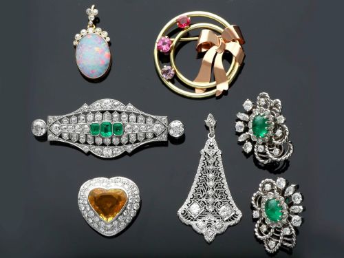 fig 7. An Edwardian 9ct yellow gold pendant featuring an oval cabochon opal surmounted by millegrain-set diamonds.