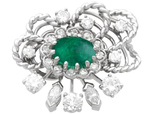fig 5. A pair of platinum and palladium clip earrings featuring oval central emeralds surrounded by brilliant-cut diamonds and rope-twist metalwork.