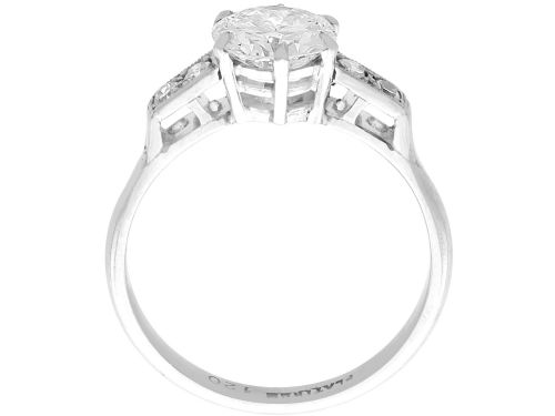 fig 7. A platinum solitaire ring set with a central round diamond and smaller diamond accents on the shoulders.