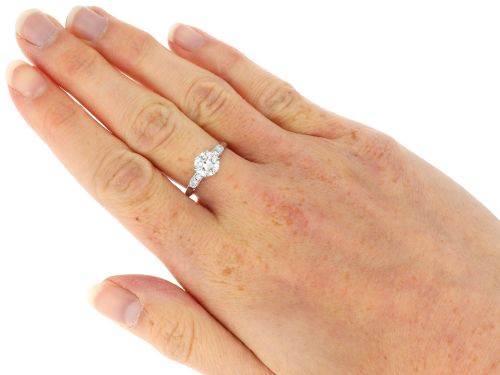 fig 8. A platinum solitaire ring set with a central round diamond and smaller diamond accents on the shoulders.
