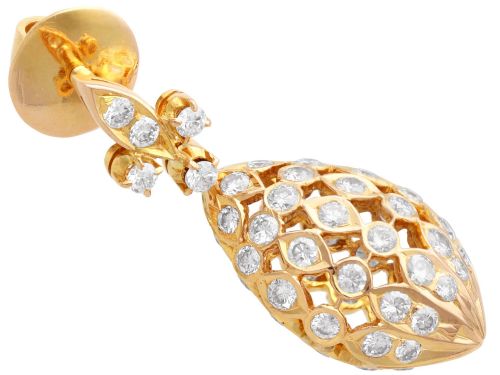 fig 6. A pair of 18ct yellow gold drop earrings featuring fleur-de-lis surmounts above openwork teardrop cages set with round diamonds.