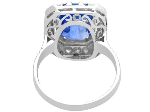 fig 6. An Art Deco 18ct white gold ring featuring a central octagonal step-cut blue Ceylon sapphire surrounded by a geometric diamond halo with milgrain details.