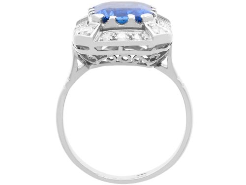 fig 7. An Art Deco 18ct white gold ring featuring a central octagonal step-cut blue Ceylon sapphire surrounded by a geometric diamond halo with milgrain details.