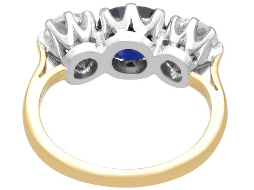 fig 8. An antique 18ct yellow gold trilogy ring featuring a cushion-shaped blue sapphire flanked by two brilliant-cut diamonds in claw settings.