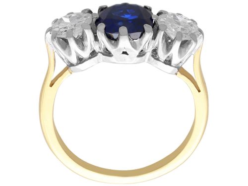 fig 9. An antique 18ct yellow gold trilogy ring featuring a cushion-shaped blue sapphire flanked by two brilliant-cut diamonds in claw settings.
