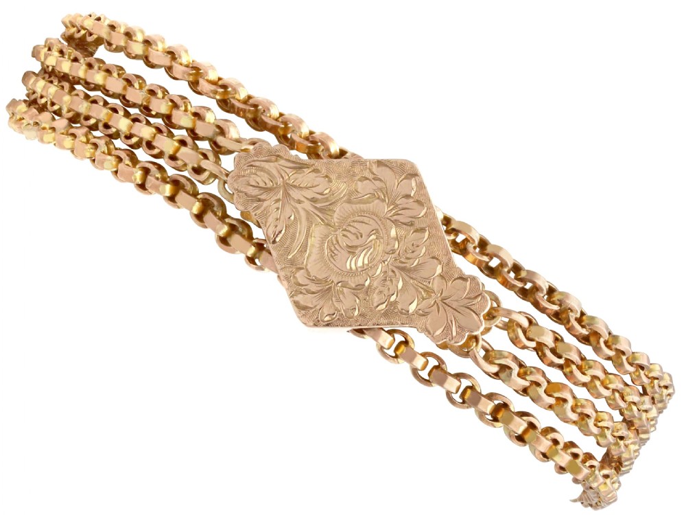 A late Victorian four-strand 9ct yellow gold belcher chain bracelet featuring a central hand-engraved lozenge-shaped panel.