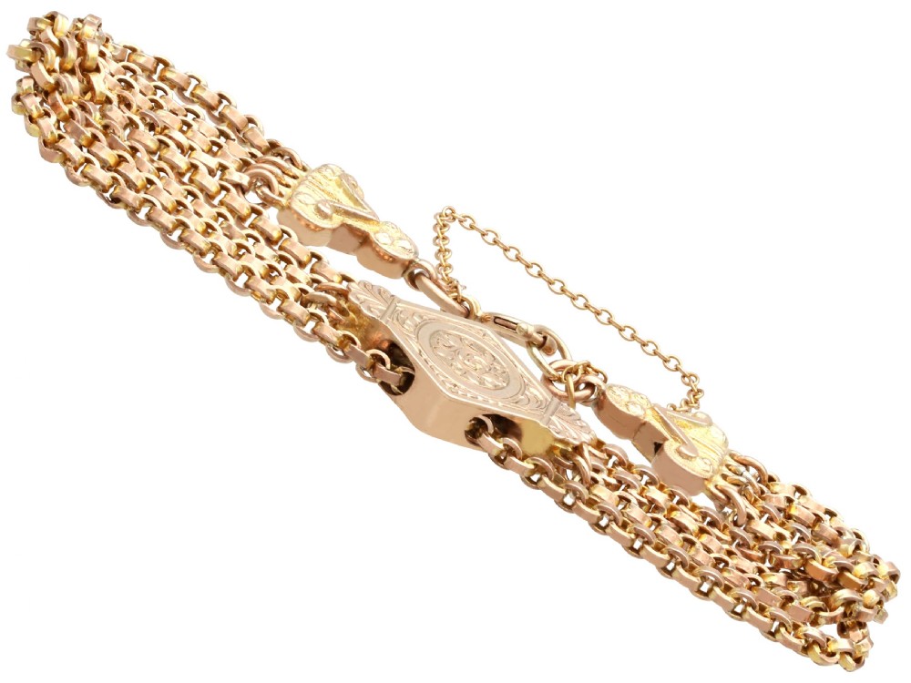 A late Victorian four-strand 9ct yellow gold belcher chain bracelet featuring a central hand-engraved lozenge-shaped panel. View IV