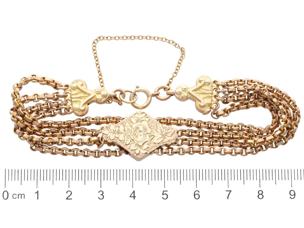 A late Victorian four-strand 9ct yellow gold belcher chain bracelet featuring a central hand-engraved lozenge-shaped panel. View IX
