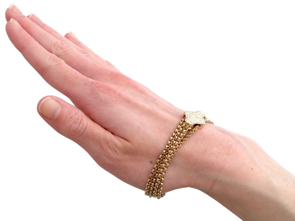 A late Victorian four-strand 9ct yellow gold belcher chain bracelet featuring a central hand-engraved lozenge-shaped panel. View XI