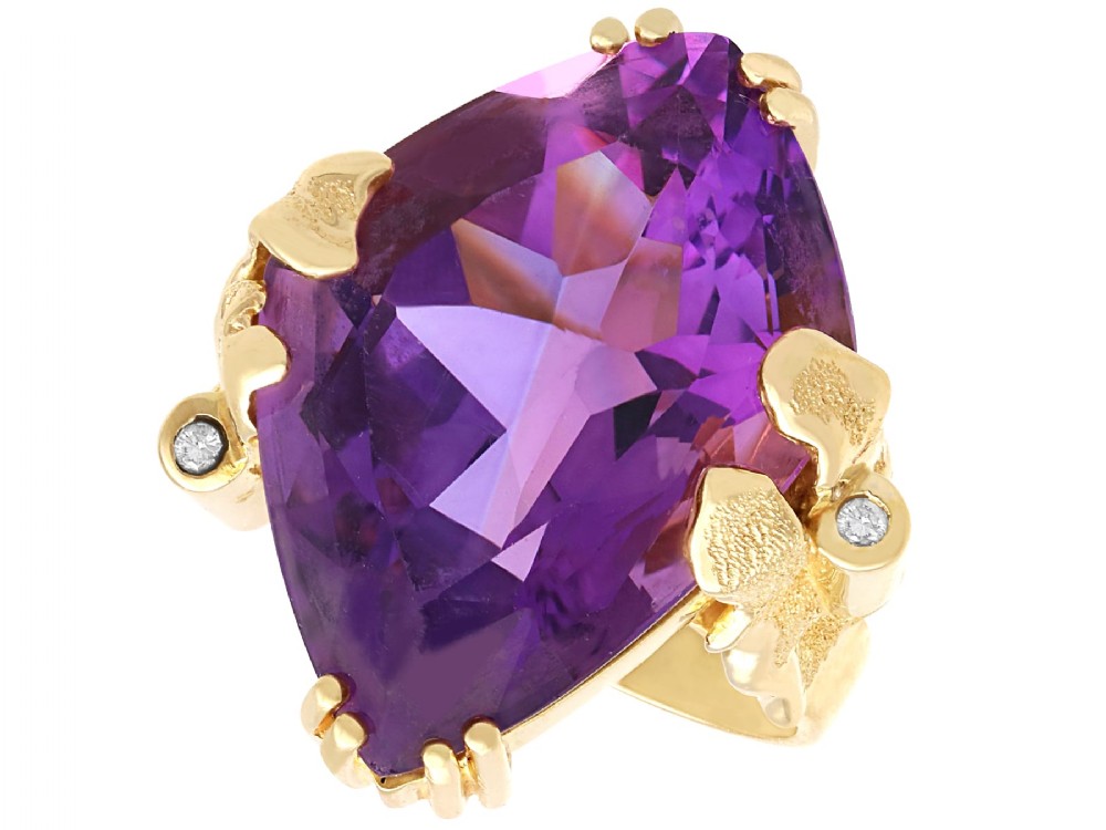 A vintage 14ct yellow gold dress ring featuring a large faceted purple amethyst with textured claw settings and small diamond accents.
