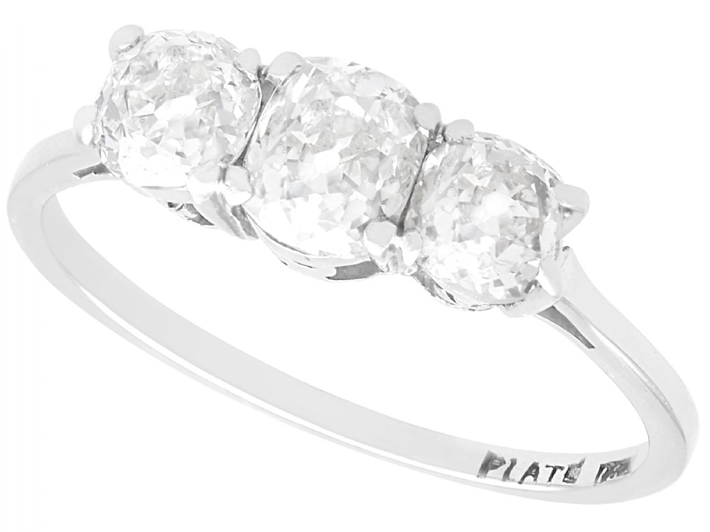An antique 18ct white gold and platinum trilogy ring set with three prominent old cut diamonds in a claw setting.