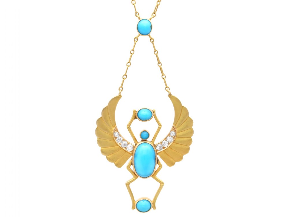 An 18ct yellow gold Egyptian Revival pendant crafted in the shape of a winged scarab beetle with turquoise cabochons and set with diamonds.