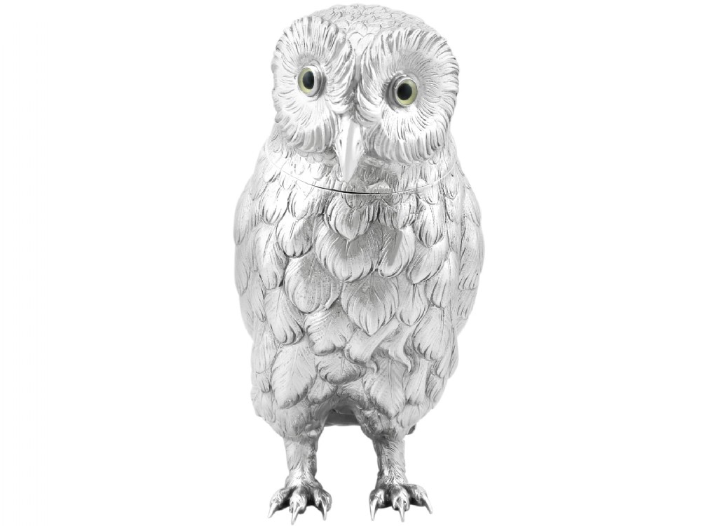 An antique sterling silver sugar box realistically cast and chased in the form of a standing owl with detailed feather textures and set eyes.