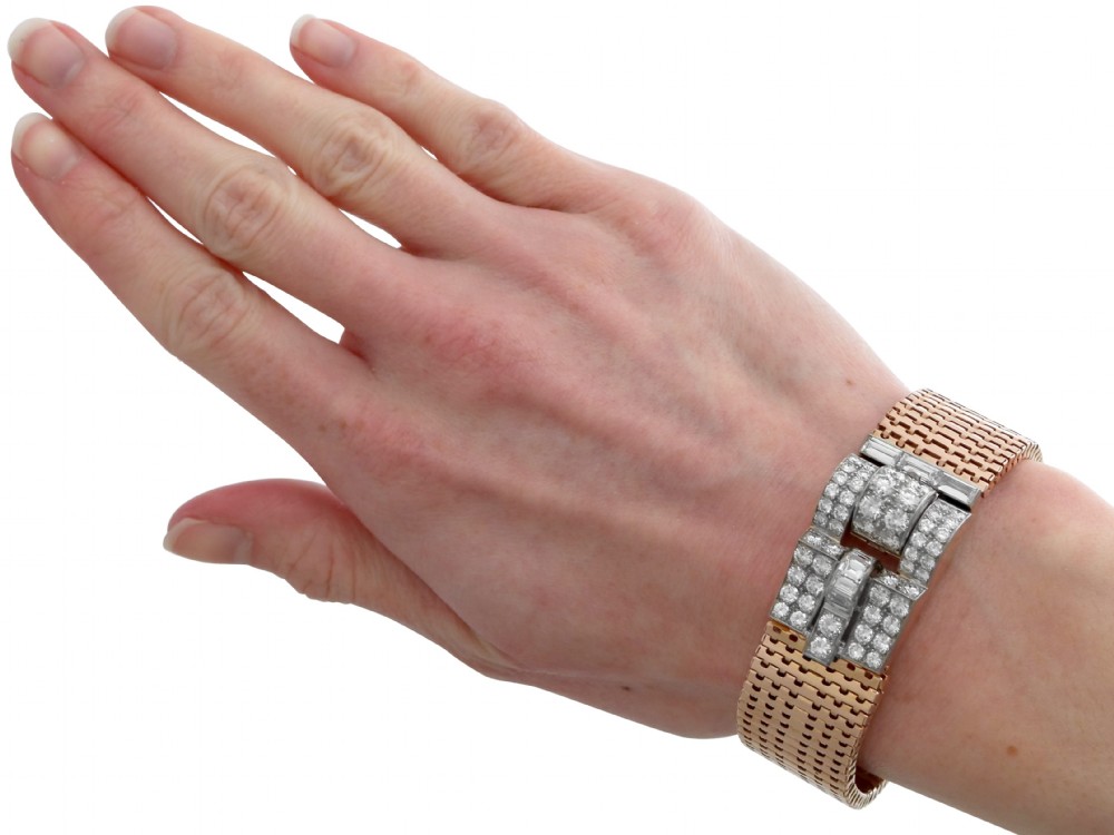 An Art Deco rose gold flexible strap bracelet featuring an articulated geometric clasp set with brilliant and baguette-cut diamonds. View XII