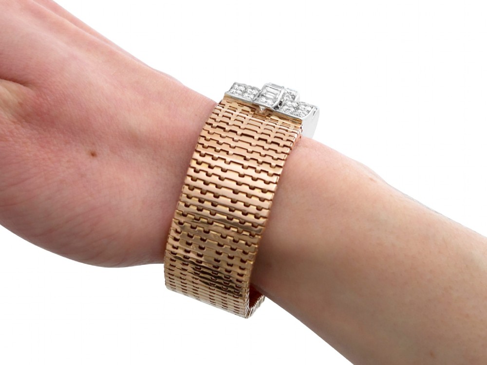 An Art Deco rose gold flexible strap bracelet featuring an articulated geometric clasp set with brilliant and baguette-cut diamonds. View XIII