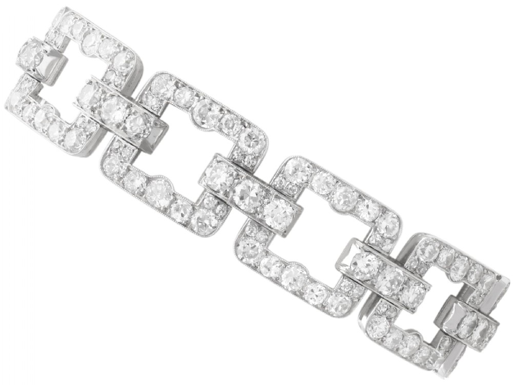 An Art Deco platinum link bracelet set with round diamonds throughout four open rectangular square links.