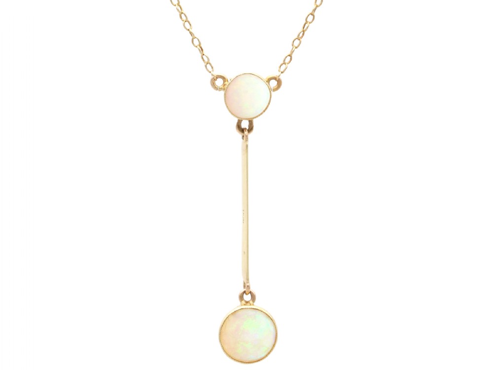 Late Victorian 15ct yellow gold lavaliere necklace featuring two bezel-set round opal cabochons linked by a straight gold bar.