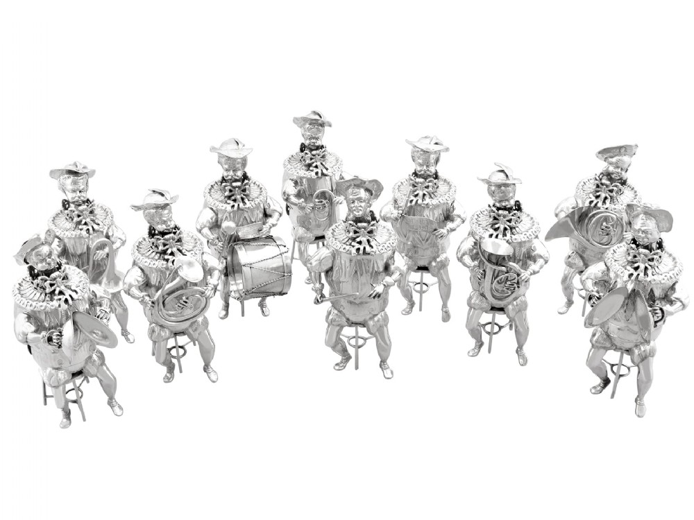 A set of German sterling silver musician figures depicting a miniature band with instruments in historic costume.