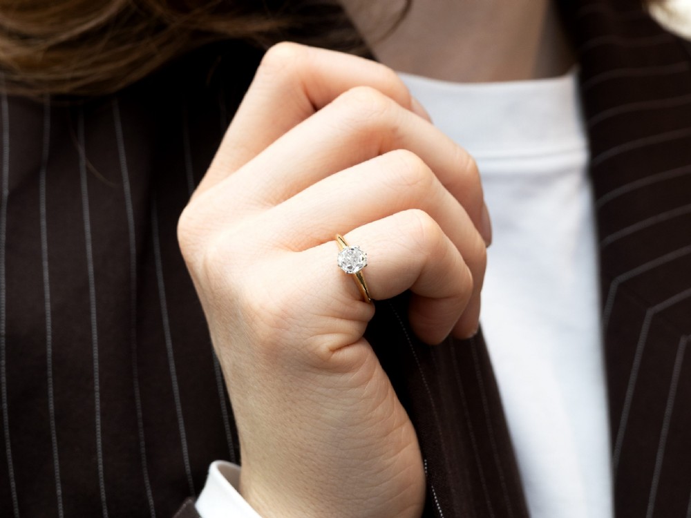 An antique 18ct yellow gold solitaire ring featuring a 1.09 carat old-cut diamond mounted in white metal claws. View III