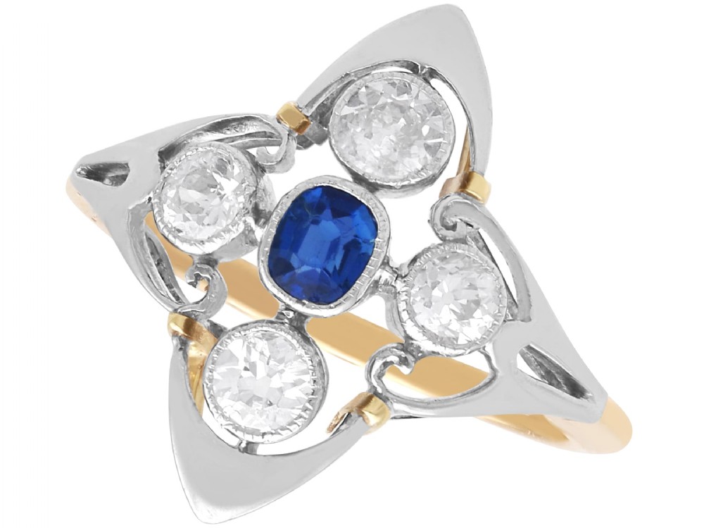 An Art Deco 14ct yellow gold ring featuring a central oval blue sapphire surrounded by four round diamonds set in a diamond-shaped openwork frame.