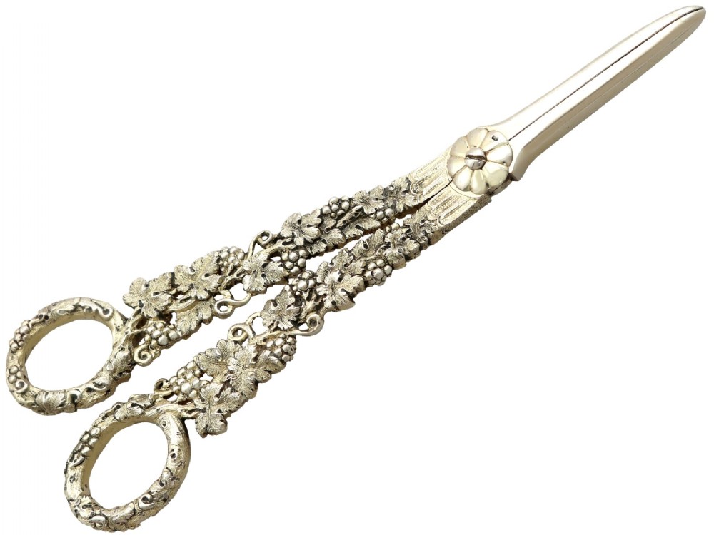 A pair of Victorian sterling silver gilt grape shears featuring cast grapevine and leaf motifs along the handles.