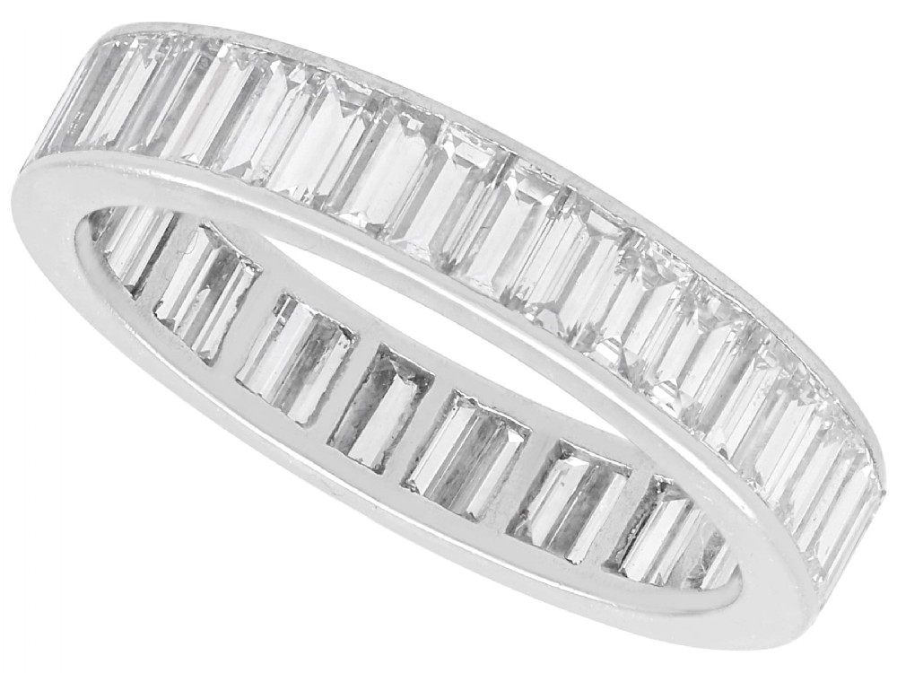 A platinum full eternity ring set with end-to-end channel-set baguette cut diamonds.