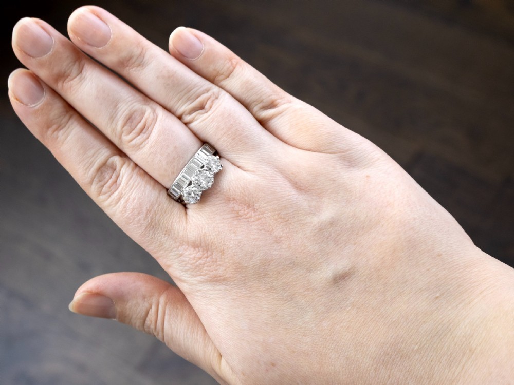 A platinum full eternity ring set with end-to-end channel-set baguette cut diamonds. View IV