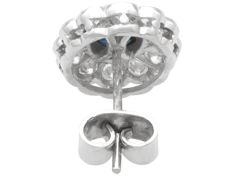 Pair of 1930s 18ct white gold cluster earrings featuring oval blue sapphire centerpieces framed by halos of round diamonds. View VIII