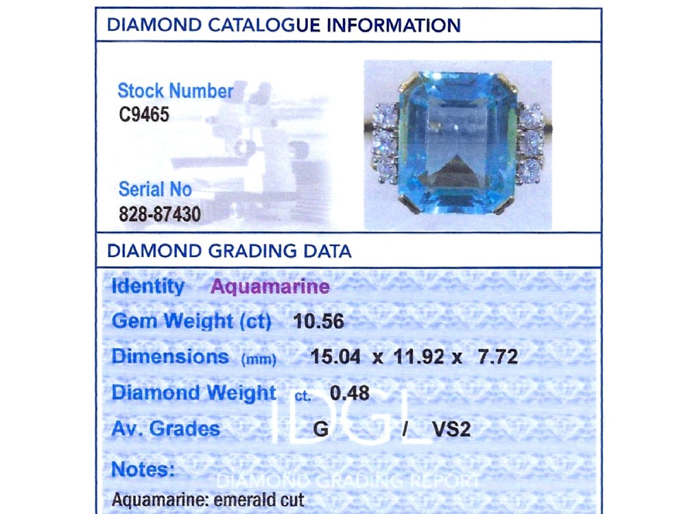 A 14ct yellow gold dress ring featuring a large emerald-cut light blue aquamarine central gemstone flanked by six round diamonds. View XII