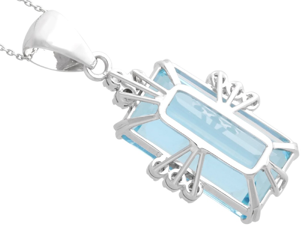 A vintage 18ct white gold pendant featuring a large emerald-cut light blue aquamarine framed by accent diamonds, suspended from an engraved bail. View IX
