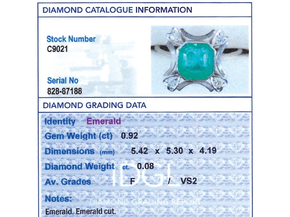 A vintage 18ct white gold ring featuring a central octagon cut green emerald framed by openwork detailing and four heart-shaped diamond mounts. View XI
