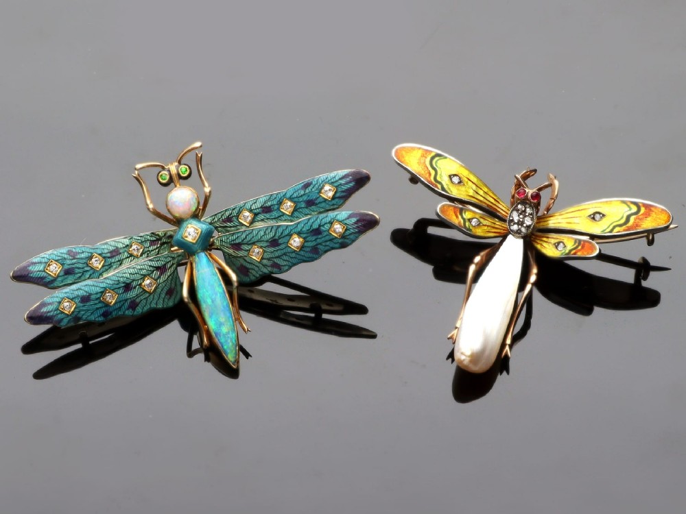 An antique late Victorian dragonfly brooch crafted in yellow gold with yellow enamel wings, garnet eyes, rose-cut diamond accents, and a elongated natural pearl abdomen. View VI