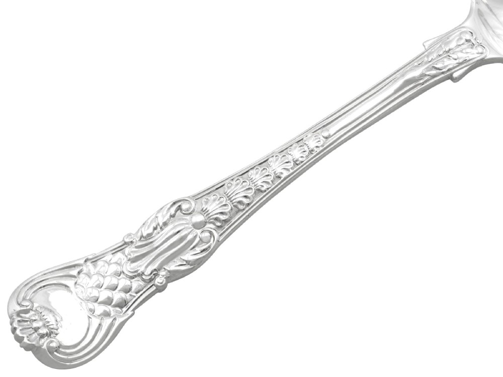 A collection of ornate sterling silver cutlery pieces featuring intricately embossed handles and polished bowls, including ladles, forks, knives, and spoons. View IX