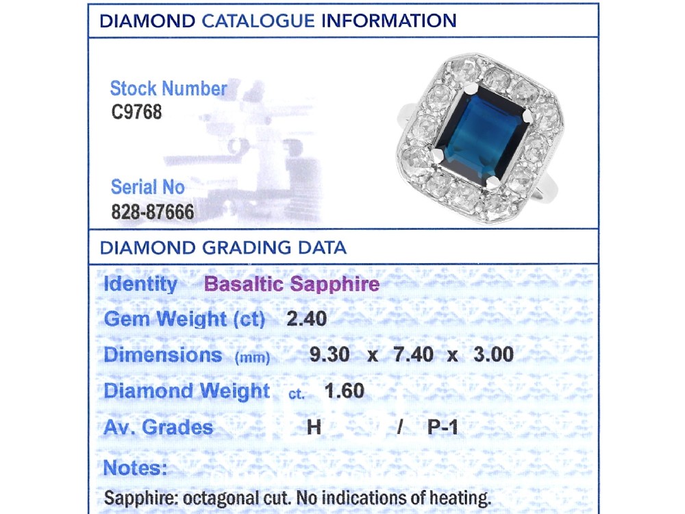 An Art Deco platinum cluster ring featuring a central rectangular blue sapphire surrounded by twelve old-cut diamonds with millegrain edges. View XIII
