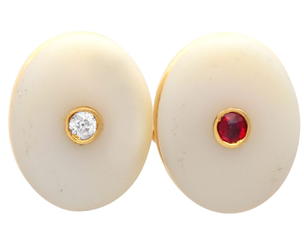 Four oval 15ct yellow gold cufflinks featuring smooth white agate faces with central bezel-set diamond, sapphire, and ruby gemstones. View VII