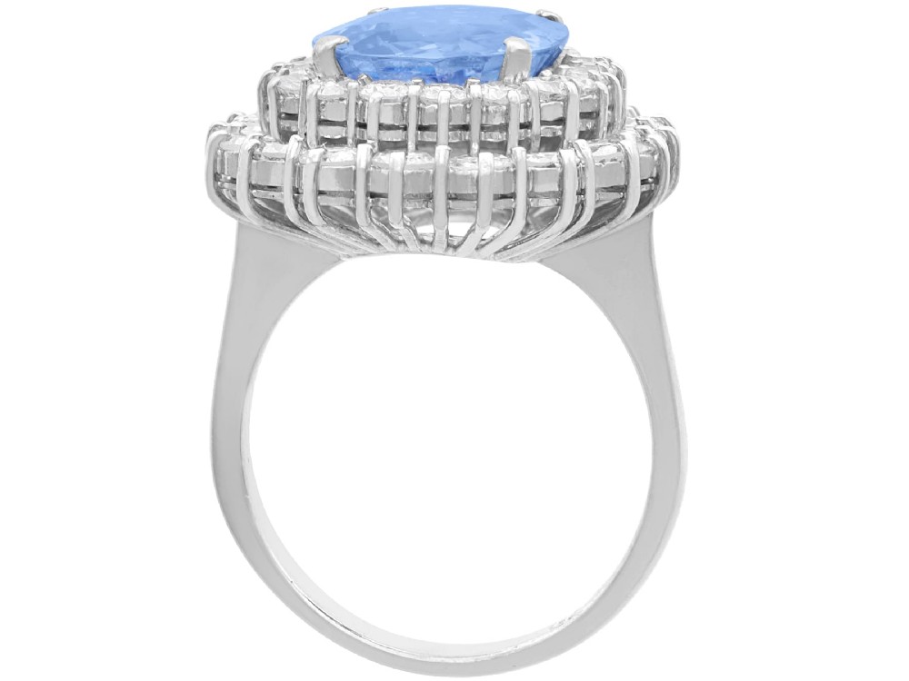 A vintage 14ct white gold cluster ring featuring a centrally mounted cushion-cut blue Ceylon sapphire surrounded by a double halo of round brilliant diamonds. View VIII
