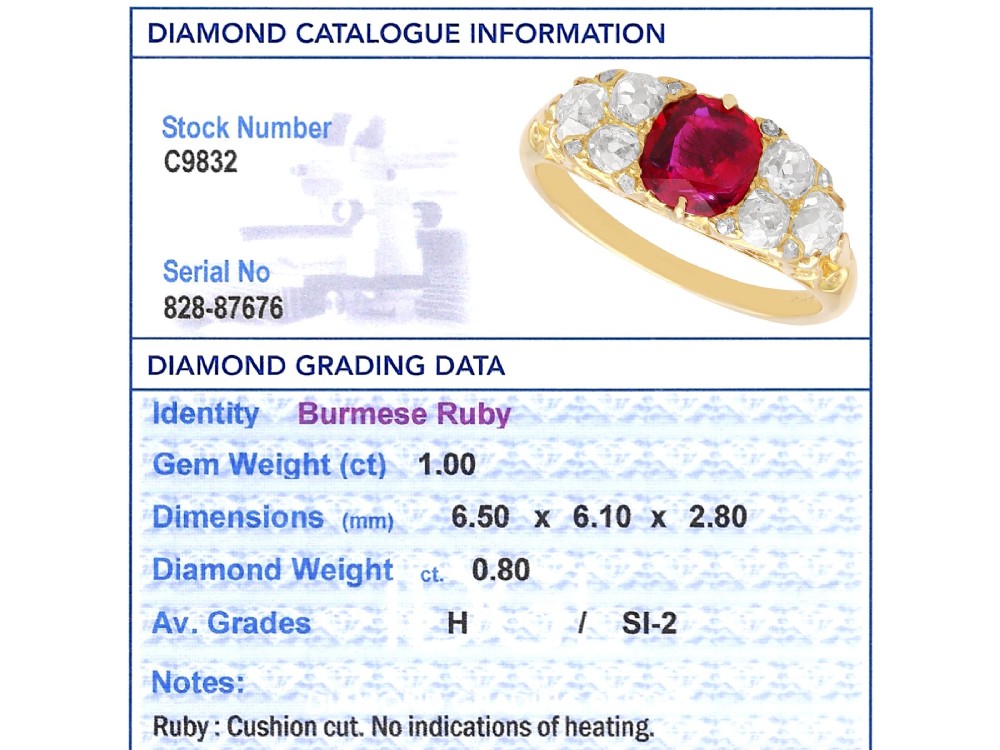 An 18ct yellow gold dress ring featuring a central cushion-cut red ruby flanked by old cut diamonds with carved scrollwork setting. View XI