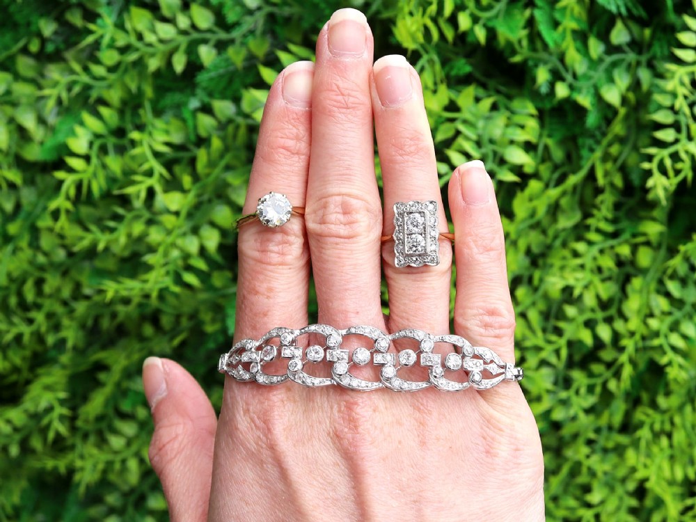 An Art Deco 18ct yellow gold dress ring with two central round diamonds within a rectangular millegrain halo setting. View III