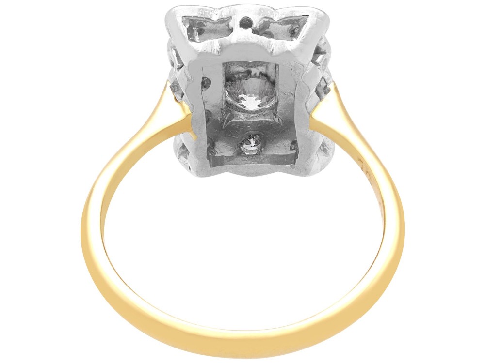 An Art Deco 18ct yellow gold dress ring with two central round diamonds within a rectangular millegrain halo setting. View VIII