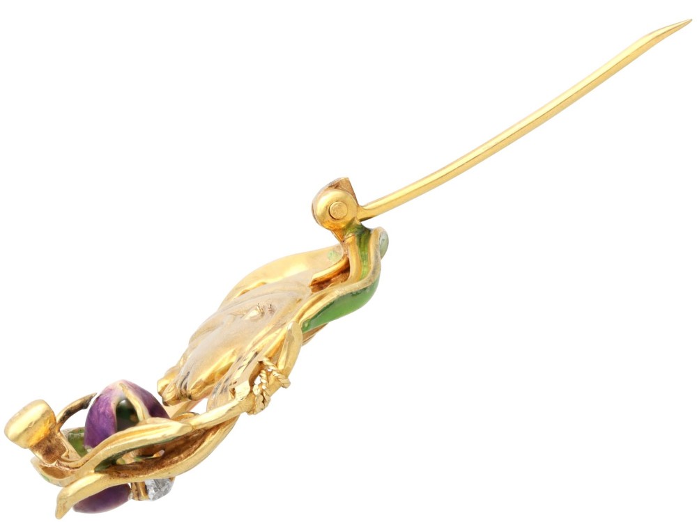 An Art Nouveau 18ct yellow gold brooch detailing a maiden profile framed by green enamel foliage and a purple enamelled iris set with a single diamond. View IX