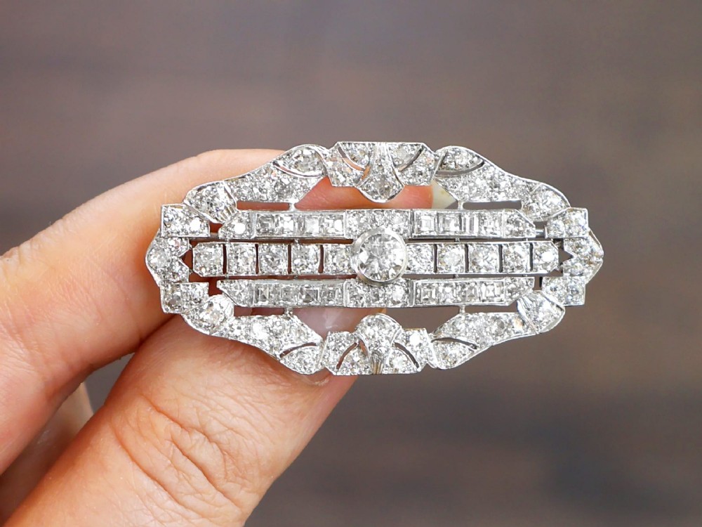 An Art Deco platinum brooch styled in an elongated geometric openwork plaque pattern, set throughout with brilliant and square-cut diamonds. View III