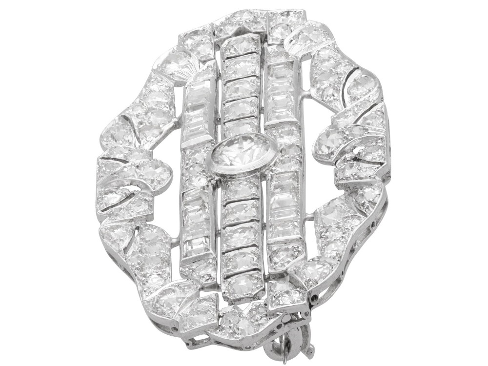 An Art Deco platinum brooch styled in an elongated geometric openwork plaque pattern, set throughout with brilliant and square-cut diamonds. View VI