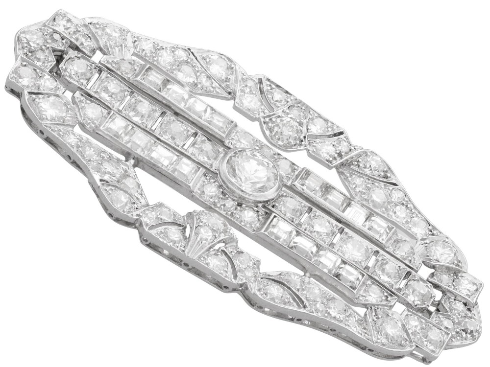 An Art Deco platinum brooch styled in an elongated geometric openwork plaque pattern, set throughout with brilliant and square-cut diamonds. View VII