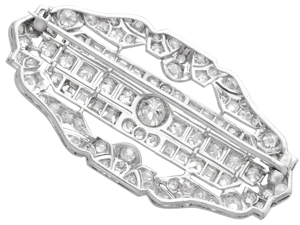 An Art Deco platinum brooch styled in an elongated geometric openwork plaque pattern, set throughout with brilliant and square-cut diamonds. View VIII